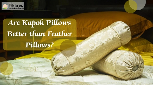 Kapok pillow beside feather pillow on a bed.