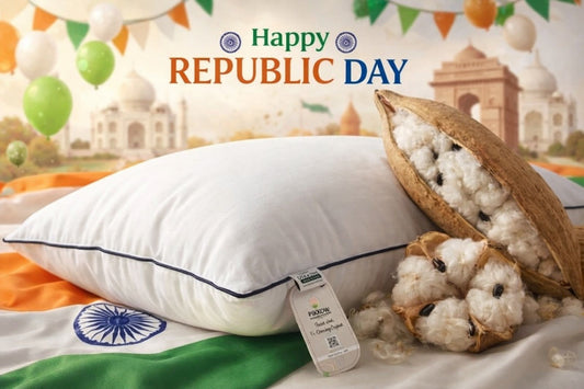 A serene bedroom setting featuring Pikkow organic kapok pillows decorated with a subtle Republic Day tricolor ribbon, highlighting eco-friendly and natural sleep